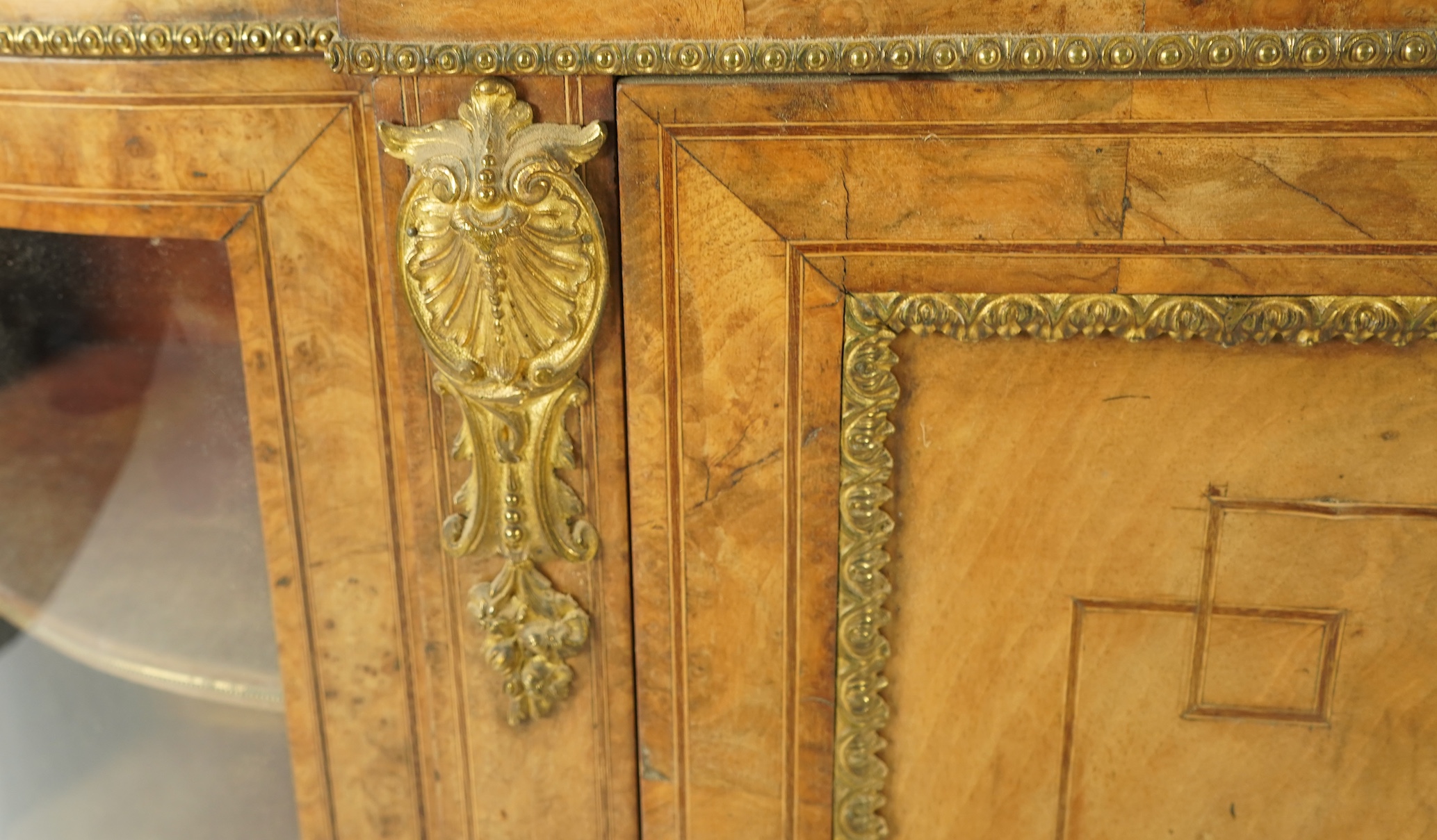 A Victorian marquetry inlaid, gilt metal mounted bowfront side cabinet